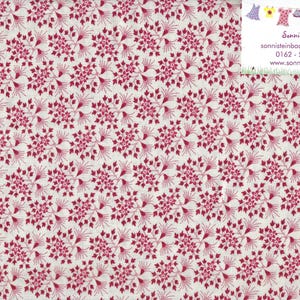 Könnte beinhalten: Weißer Stoff mit einem sich wiederholenden Muster aus bordeauxfarbenen floralen Designs. Das florale Muster besteht aus Clustern kleiner, stilisierter Blumen und zarten, strahlenförmigen Linien. Ein Lineal befindet sich auf der rechten Seite, mit Messungen in Zentimetern.