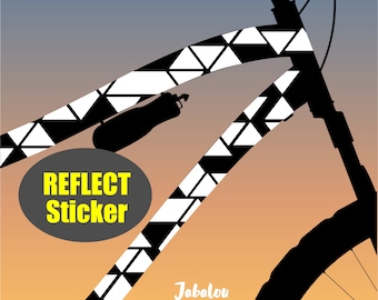 May include: Black and white geometric pattern bike frame sticker with the text "Reflect Sticker" in yellow on a gray circle. The sticker is applied to a black silhouette of a bicycle frame.