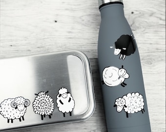 Könnte beinhalten: Ein Set aus zwei Edelstahlbehältern mit einem schwarzen und weißen Schafdesign. Der größere Behälter ist eine Lunchbox und der kleinere Behälter ist eine Wasserflasche.