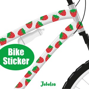 May include: White bicycle frame with a sticker design of red strawberries on a white background. The sticker reads "Bike Sticker" in green text. The text "Jabalou" is written in green at the bottom of the image.