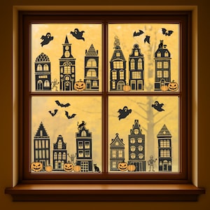 May include: A wooden window frame with Halloween decorations. The window panes display black silhouettes of spooky houses, pumpkins, bats, ghosts, and a skeleton. The background shows a blurred, golden-yellow autumn scene.
