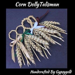 May include: Three handmade corn dolly talismans with wheat stalks and tied with ribbons in green, white and gold.