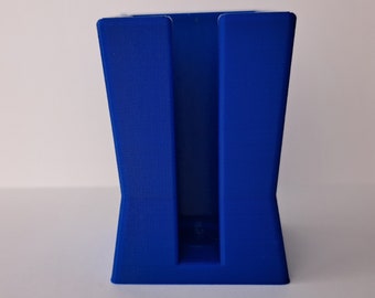 May include: A blue plastic organizer with a single slot for holding items. The organizer has a rectangular shape with a slightly flared base.