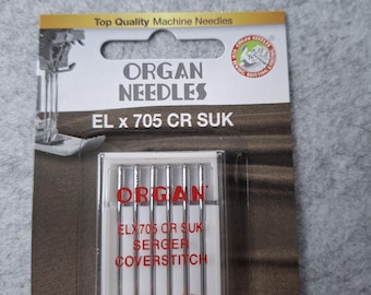 May include: A package of Organ needles for serger and coverstitch machines. The package is red, white, and black and features the text "Organ Needles" and "EL x 705 CR SUK". The needles are in a clear plastic case and are labeled with the sizes 80/12 and 90/14.