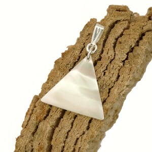 May include: A white triangle pendant made of mother of pearl with a silver bail.