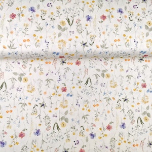 May include: White fabric with a delicate floral pattern featuring small, scattered flowers in shades of pink, yellow, blue, and green.