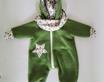 May include: A green fleece baby onesie with a white star and floral print trim. The onesie has a hood with a floral print lining.