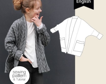 May include: A gray cardigan with a white pattern and two pockets. The cardigan is open and a child is wearing it. The image also includes a line drawing of the cardigan.