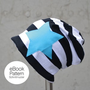 May include: Black and white striped beanie with a large turquoise star on the front. eBook Pattern Schnittmuster is written on a white circle.