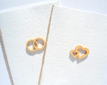 Elegant handmade paper wedding card with golden hearts or rings