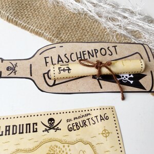 May include: A brown paper bottle with a rolled up scroll inside. The bottle has the text "FLASCHENPOST" written on it. The scroll is tied with twine. The bottle is on a white surface. Below the bottle is a brown paper map with the text "Einladung zu meinem Geburtstag" and a skull and crossbones.