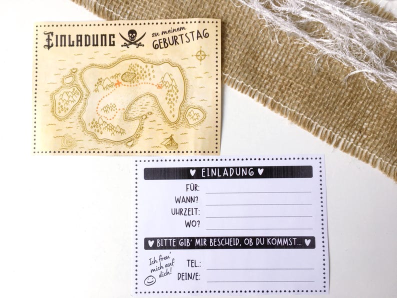 May include: A black and white printable invitation card with a pirate treasure map design. The text on the card reads "Einladung zu meinem Geburtstag" which translates to "Invitation to my birthday".