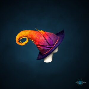May include: A purple and orange felt witch hat with a curled brim and a long, pointed, curled top. The hat is on a mannequin head.