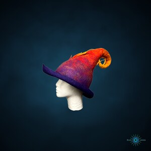 May include: A purple and orange felt witch hat with a curled brim and a long, pointed, curled top. The hat is on a white mannequin head.
