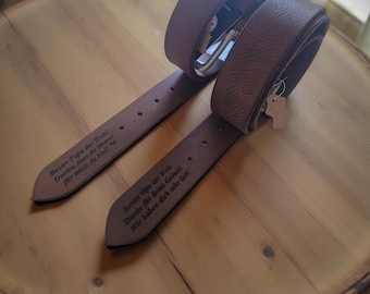 Puede incluir: Dos cinturones de cuero marrón con hebillas de metal plateado. Los cinturones presentan un texto grabado en alemán en la parte interior. Uno dice, Bester Papa der Welt. Danke, dass du immer für mich da bist! El otro dice, Bester Opa der Welt. Danke für deine Geduld. Wir haben dich sehr lieb!
