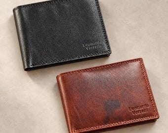 May include: Two bi-fold wallets, one in black and one in brown, both featuring a textured finish and the brand name Leonardo Verrelli embossed in the bottom corner. The wallets are rectangular with visible stitching along the edges.
