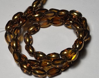 Glass beads plated gold edge oval 7x5x4mm