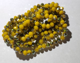 Glass beads Glass cut beads 8 x 6 mm half green gold plated