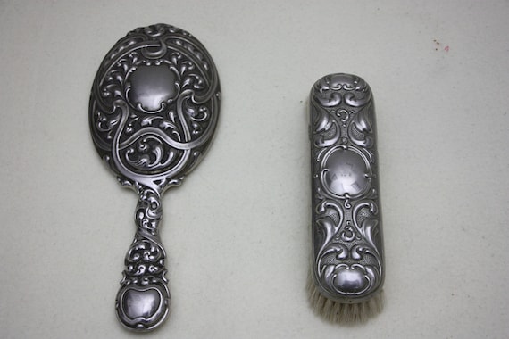 Antique hairdressing mirror with hairbrush, make-u