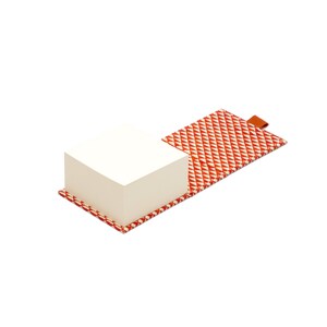 May include: A white notepad with a red and white geometric patterned cover. The notepad is open and the cover is folded back.