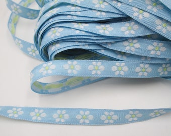 1.50 m narrow woven border light blue with floral pattern white/yellow (1 cm wide) 5-7-21