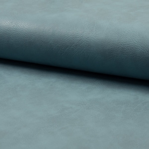 May include: Close-up of a blue faux leather fabric with a textured surface.