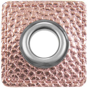 May include: A square, rose gold-colored fabric patch with a silver grommet in the center. The fabric has a textured, pebbled surface.