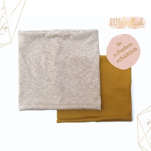 Könnte beinhalten: Zwei Stoffmuster, eines beige und eines senfgelb, werden auf weißem Hintergrund gezeigt. Der Text "In 11 Farben erhältlich" ist in einem rosa Kreis sichtbar.