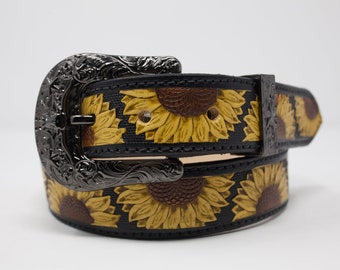 May include: A black leather belt with a silver buckle and a sunflower pattern.