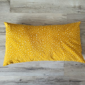 Pillowcase with irregular white dots on mustard yellow