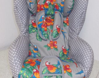 May include: A gray car seat cover with a tropical parrot print. The cover features a gray background with white polka dots and a colorful parrot design with red, orange, blue, and green accents.