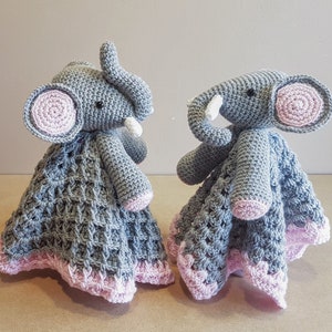 May include: Two gray crocheted elephant baby blankets with pink accents. The elephants have white yarn for tusks and black eyes. The blankets are made with a waffle stitch pattern.