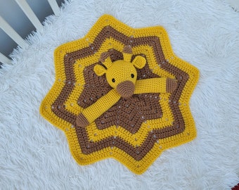 May include: A crocheted yellow and brown star-shaped baby blanket with a crocheted giraffe toy in the center.