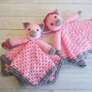 May include: Two pink crocheted pig baby blankets with grey trim. One pig has a red bow and the other has a red apple. Pattern by Crafting Happiness