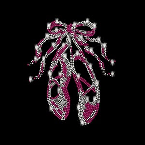 May include: Pink and white ballet shoes with a bow made of rhinestones.