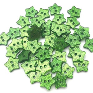 May include: A pile of green glitter star-shaped buttons.