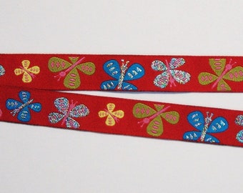 Woven ribbon "Glittering Flatterlis", red background