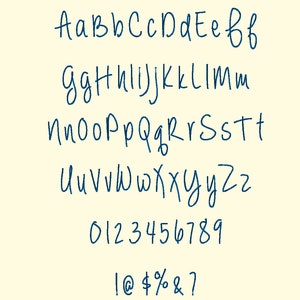 May include: A handwritten font sample in dark blue on a cream background. The image displays the alphabet in both uppercase and lowercase, along with numbers 0-9 and symbols like !, @, $, %, &, and ?. The font has a casual, flowing style.