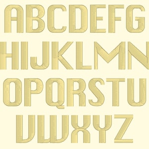 Puede incluir: Una fuente de alfabeto dorada con un aspecto texturizado y bordado. Las letras están en mayúsculas y están dispuestas en tres filas.