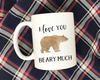 May include: White ceramic coffee mug with a brown bear silhouette and the text "I love you Beary Much".