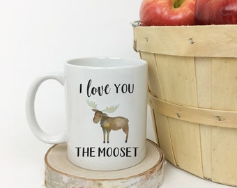 May include: White ceramic coffee mug with a moose illustration and the text "I love you the mooset".