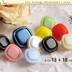 May include: Assortment of ten vintage glass buttons in various colors, including black, white, blue, green, yellow, red, pink, and light blue. The buttons are square with rounded corners and have a raised design. The buttons are approximately 13 mm and 18 mm in diameter.
