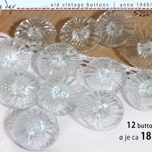 May include: A collection of twelve clear, vintage glass buttons. Each button has a radial design and is approximately 1.8 cm in diameter. The buttons are from the 1940s, 50s, and 60s. The image includes the text "old vintage buttons" and "12 buttons".