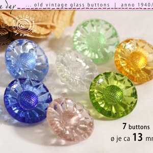 May include: Seven round vintage glass buttons with a faceted floral design and a textured center. The buttons are in various translucent colors including blue, green, yellow, and clear. Each button measures approximately 13 mm in diameter.