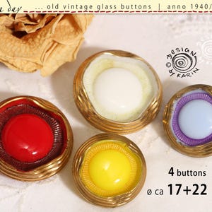 May include: Four round glass buttons with metallic gold-toned rims. The buttons feature central coloured inserts in red, white, yellow, and light purple. Text on the image indicates 4 buttons with diameters of approximately 17 and 22 mm.