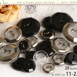 May include: A collection of vintage glass buttons in various sizes and shapes. The buttons are primarily black and clear, with faceted and round designs. The image includes text that reads "old vintage glass buttons" and "20 buttons" with sizes ranging from 11-22 mm.