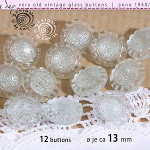 May include: A collection of twelve clear glass buttons, each measuring approximately 13 mm in diameter. The buttons feature a textured, faceted centre with a scalloped edge design. The text "12 buttons" and "ø je ca 13 mm" is visible.
