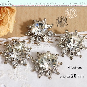 May include: Four vintage strass buttons from the 1950s/60s, each with a central clear crystal surrounded by smaller crystals. The buttons are approximately 20 mm in diameter. The image includes text that says "rosa day" and "design by karin".