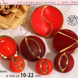 May include: Seven vintage glass buttons in red and burgundy, with gold-coloured trim. The buttons have various shapes and designs, with sizes from 10 to 22 mm. The image includes text: "rosa day... old vintage glass buttons | anno 1940/50/60".