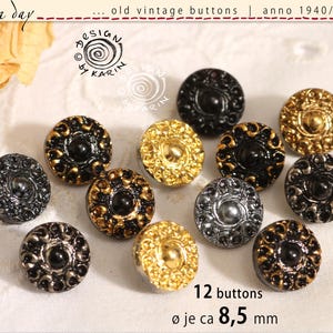 May include: A collection of twelve vintage buttons, circa 1940-1960, in various colors including black, gold, and silver. Each button has a diameter of approximately 0.33 inches and features an ornate design.